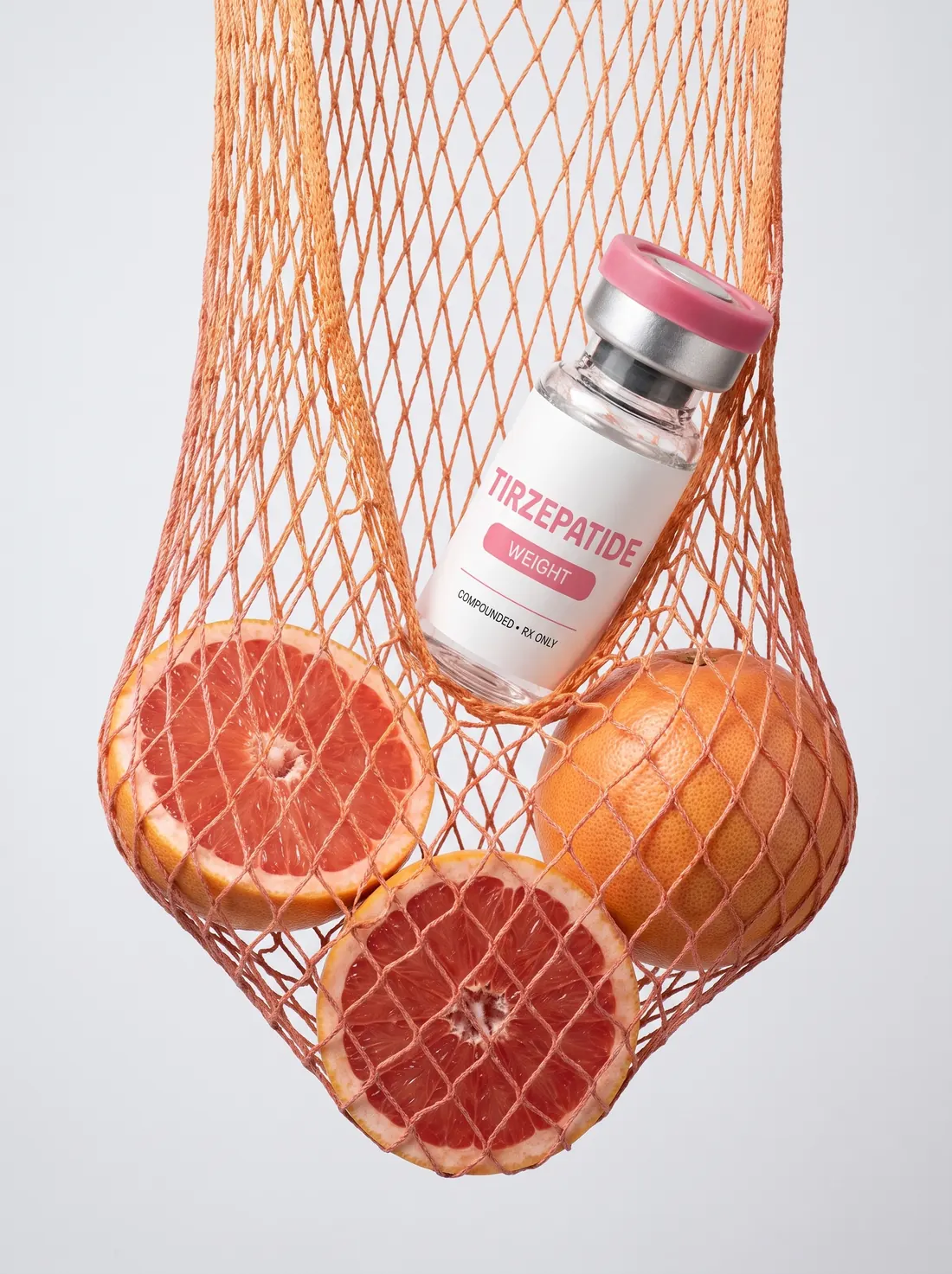 Compounded Tirzepatide vial and grapefruit in an orange net bag